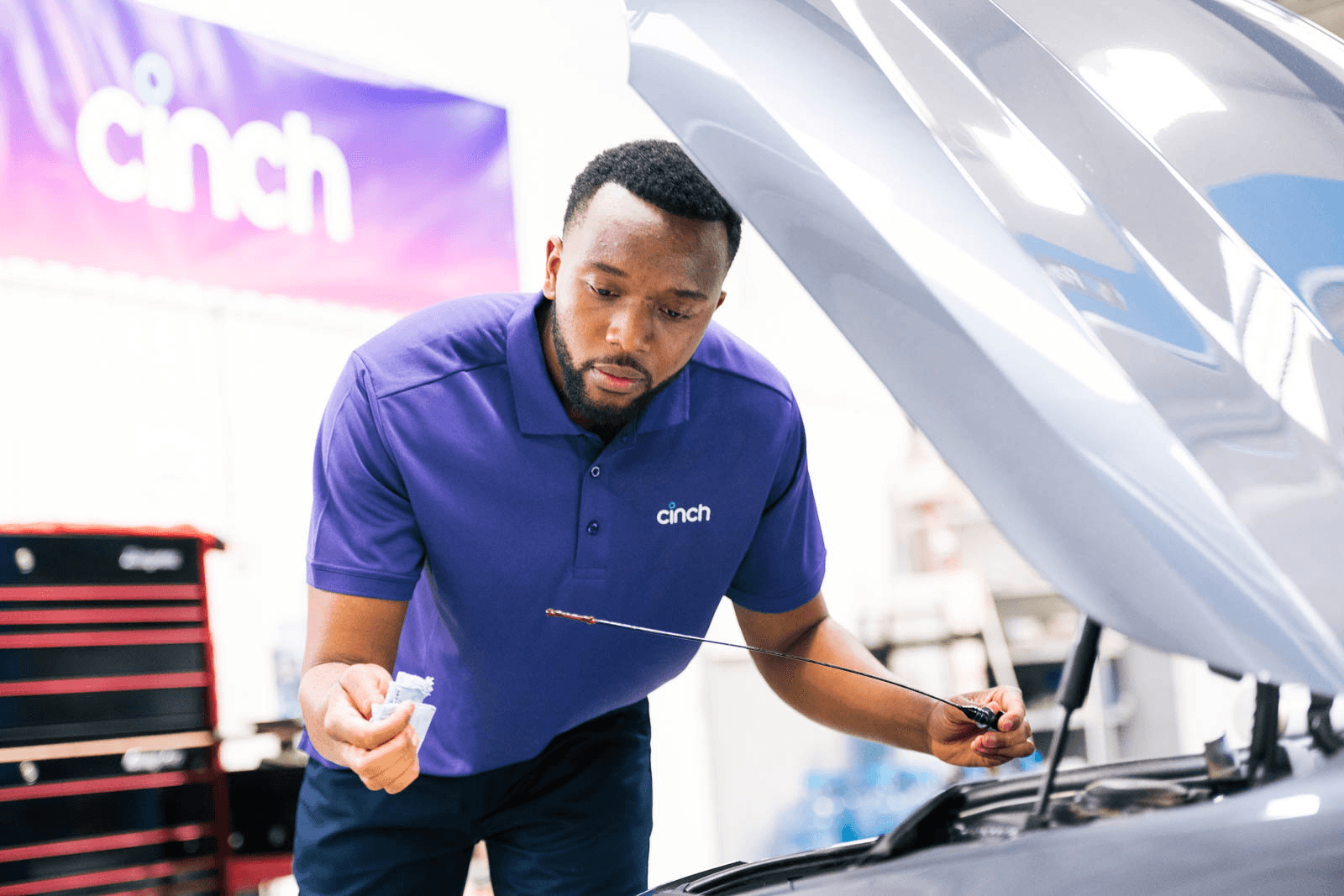 cinch technician inspecting a car engine